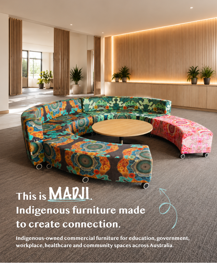 A curved modular upholstered seating unit in a modern interior lobby. The main seating section has a bold multicolor floral and geometric pattern in teal, orange, yellow, and green, while the adjacent ottoman is pink and floral.